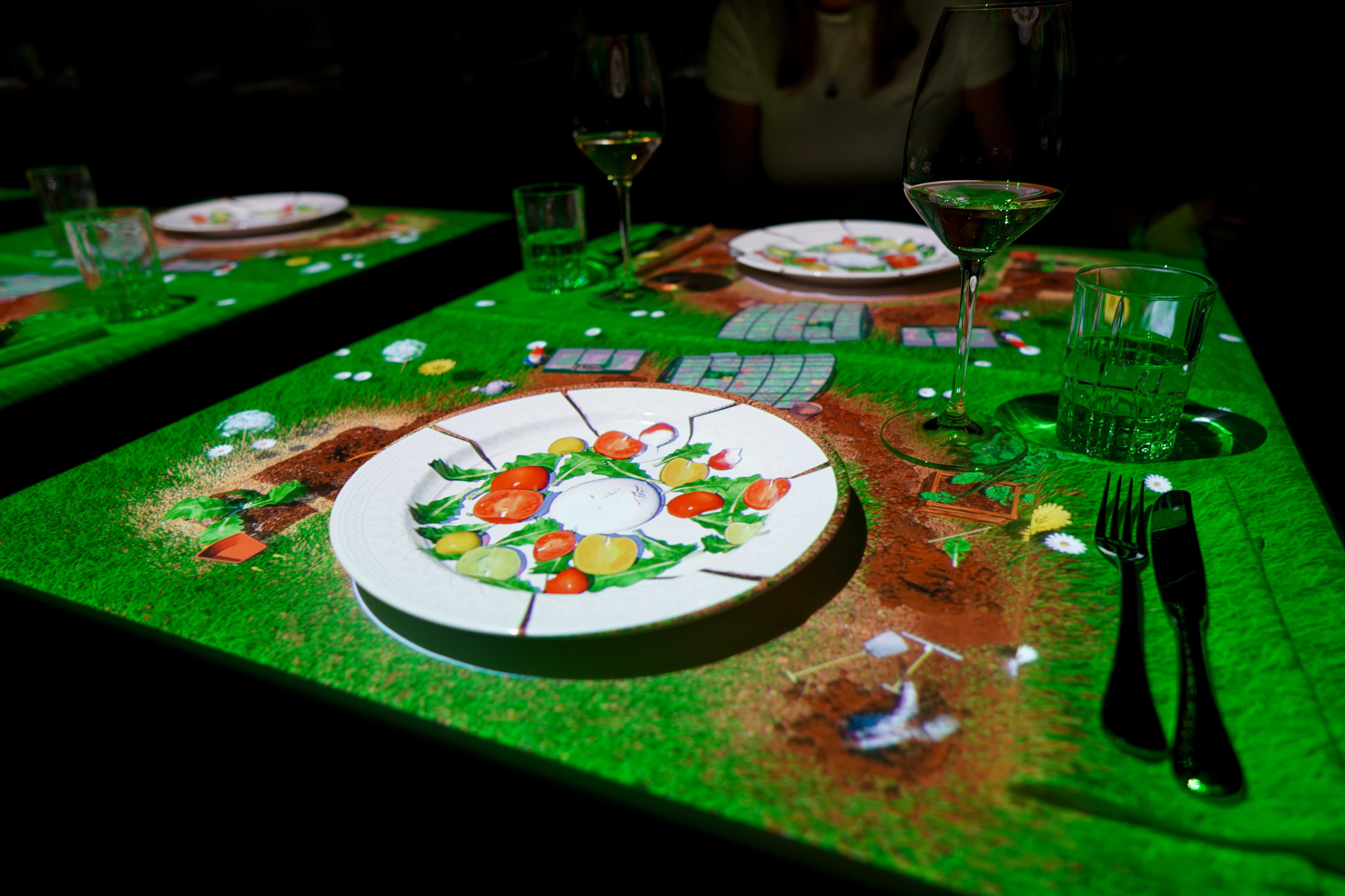 Dinner table with a cartoon scene projected on top