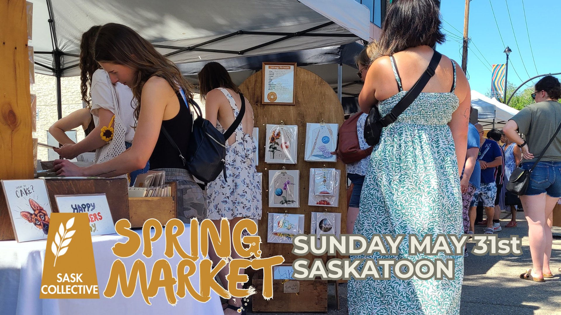 outdoor market scene with women in sundresses and a booth with art prints