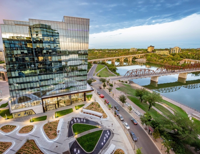 Aerial view of the city of Saskatoon with the river and large buildings in the background