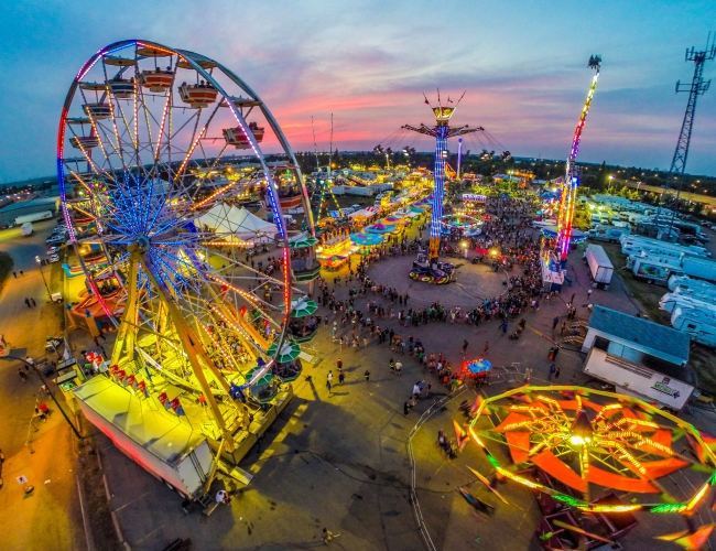 Amusement park rides lit up at night