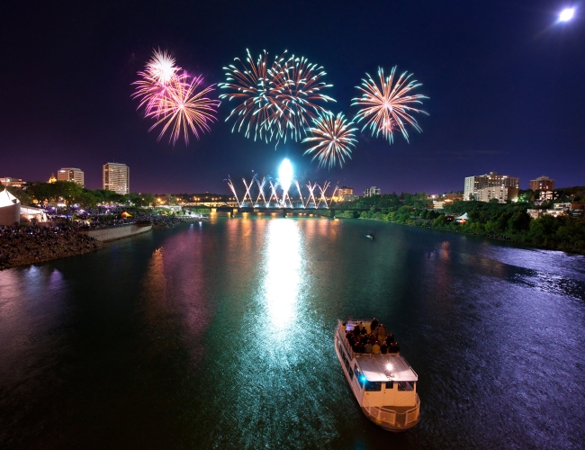 Fireworks at night, exploding over the city skyline of Saskatoon