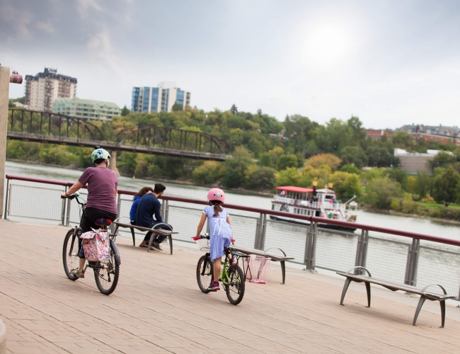 Family on bicycles cycling by the water