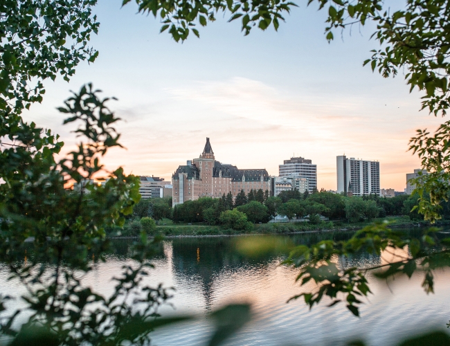 The city of Saskatoon as seen from across the water at sunrise