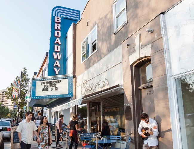 a crowd of people outside the Broadway theatre. 