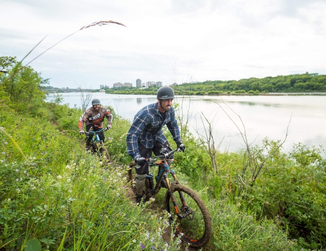 couple cycling on a trail by the water