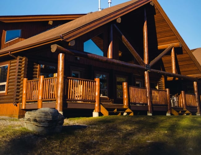 The exterior of a large, luxury log cabin