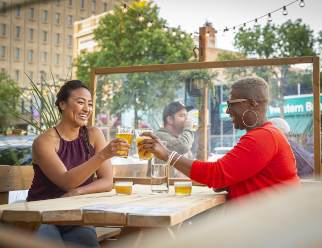 Women sitting on a restaurant patio having drinks