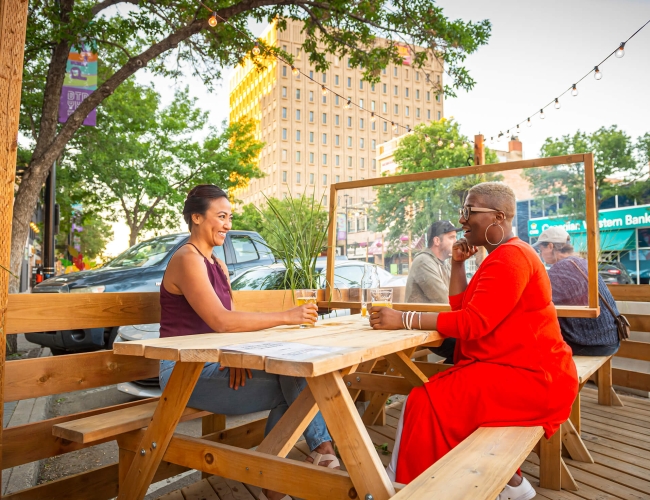 women sitting at an outdoor patio table at a restaurant