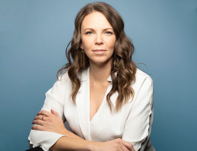 Headshot of Stephanie Clovechok against a blue background