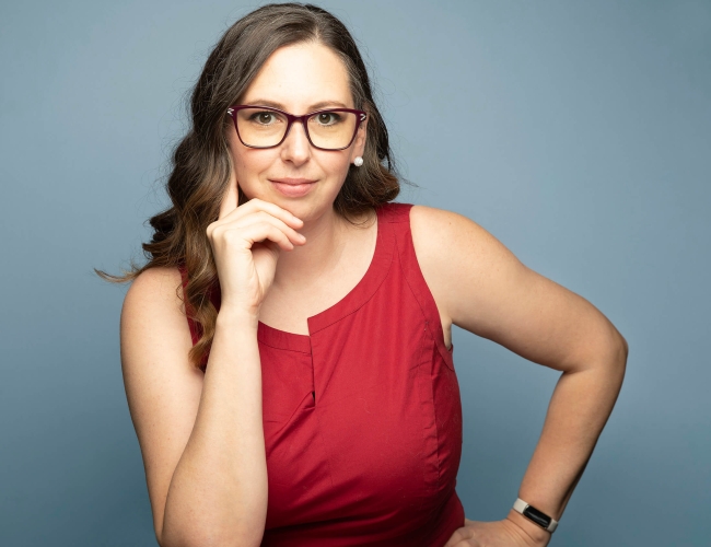 Headshot for Danielle Byl against a blue background