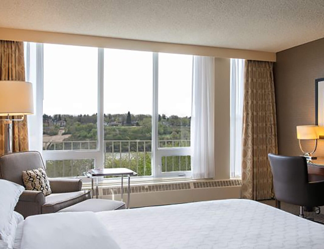 Hotel bedroom looking over greenery 