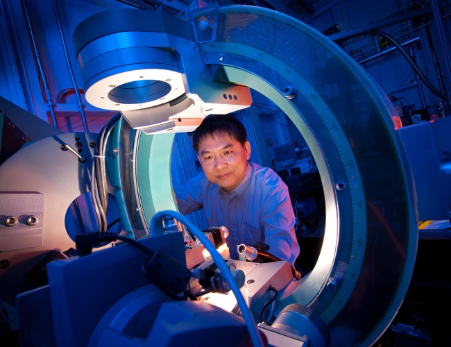 Man looking into machinery 