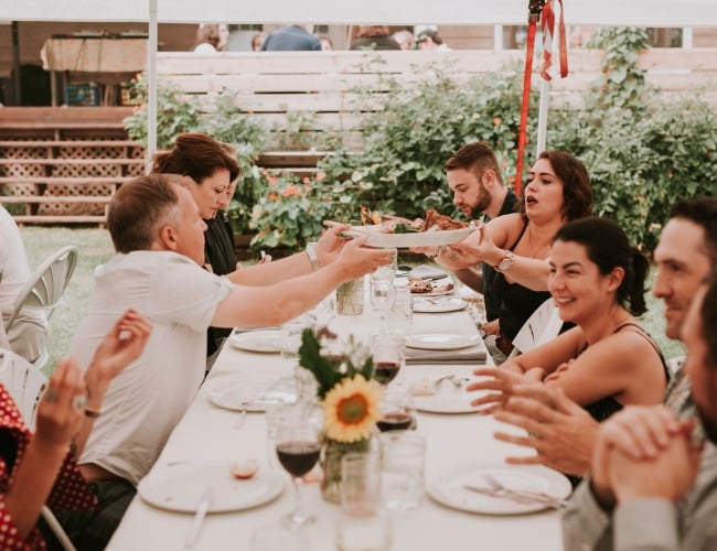 People share plates in a beautiful outdoor setting
