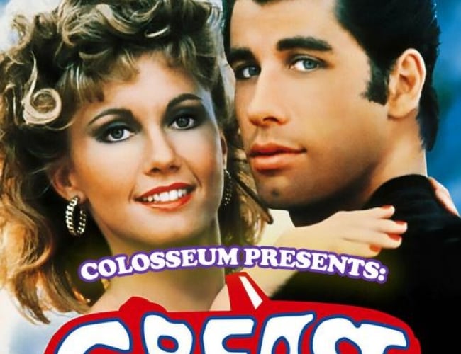Image from the movie Grease with John Travolta and Olivia Newton-John. Shows them hugging while looking at the camera.