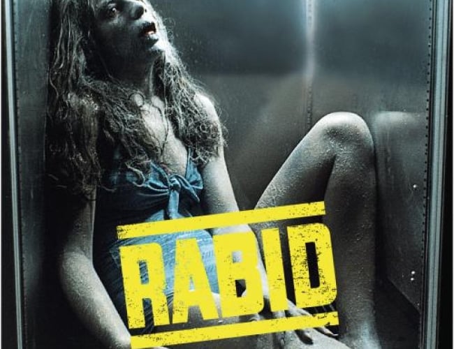 Image from the movie; rabid. Shows a girl in a blue dress frozen with her mouth open, in a small fridge possibly.