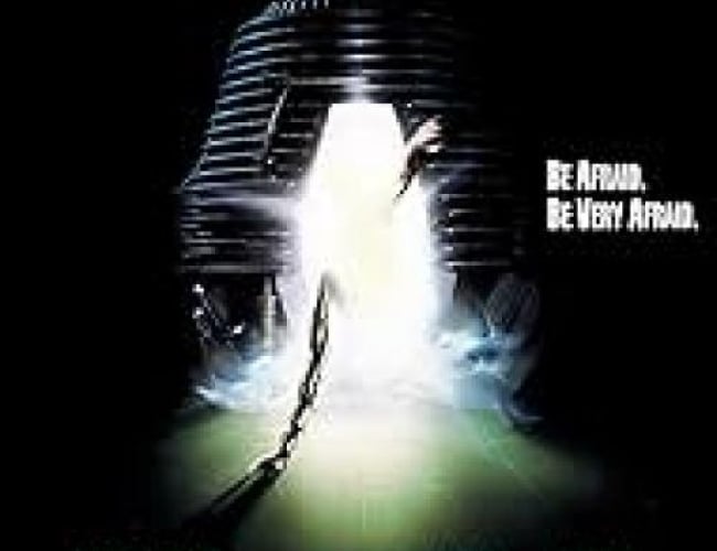 Image of the movie poster; The Fly. A pod with bright light is shown with a chain coming out of it. 