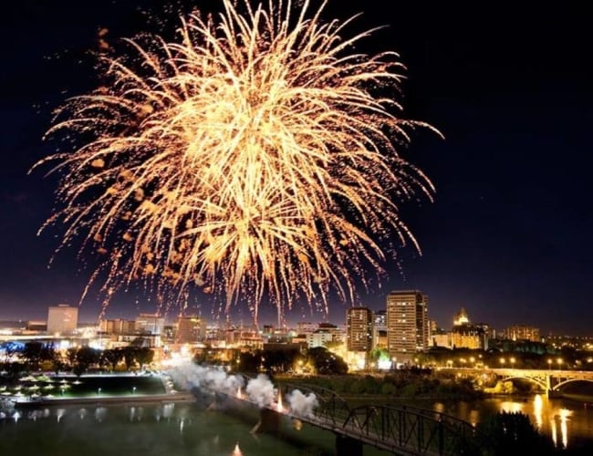 Fireworks in the dark over a river