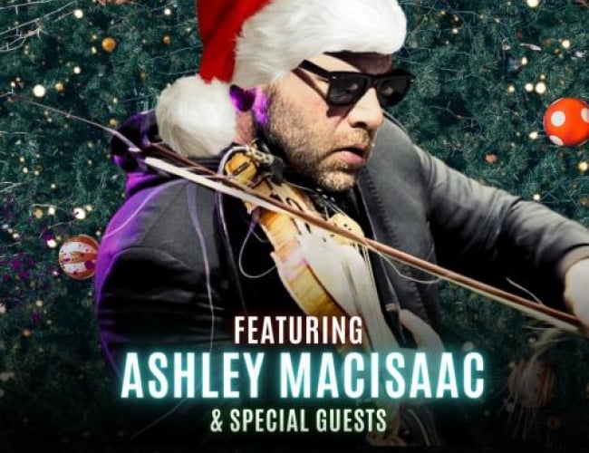 Image of Ashley MacIsaac playing the fiddle wearing sunglasses and a Santa hat. The background is a decorated Christmas tree. Along the bottom are logos for SK Arts, The Broadway Theatre, and City of Saskatoon. Text is Written: Christmas from the Atlantic Featuring Ashley MacIsaac & Special Guests 7:30PM Thursday November 20th The Broadway Theatre