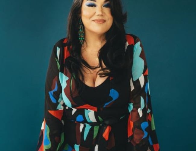 Image of Celeigh Cardinal sitting in front of a solid teal background. Text is written Celeigh Cardinal October 10th The Broadway Theatre Dakota Dunes Community Development Corporation Tickets at broadwaytheatre.ca