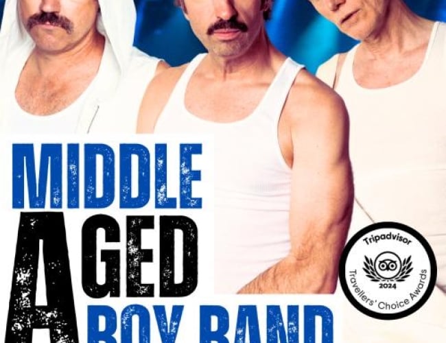 Image of three middle aged guys wearing white muscle shirts. The one on the left has a white hood, the one on the right has a white backwards hat. All standing in front of blue stage lights. With large text covering the bottom half of the poster and logos along the bottom. Text is written the Comedy Department Middle Aged Boy Band A Music Parody and Comedy Show Trip Advisor Travelers Choice Awards As Seen On CBC, Canadian Comedy Awards, The Debaters, Just for Laughs, The Second City, and Netflix.