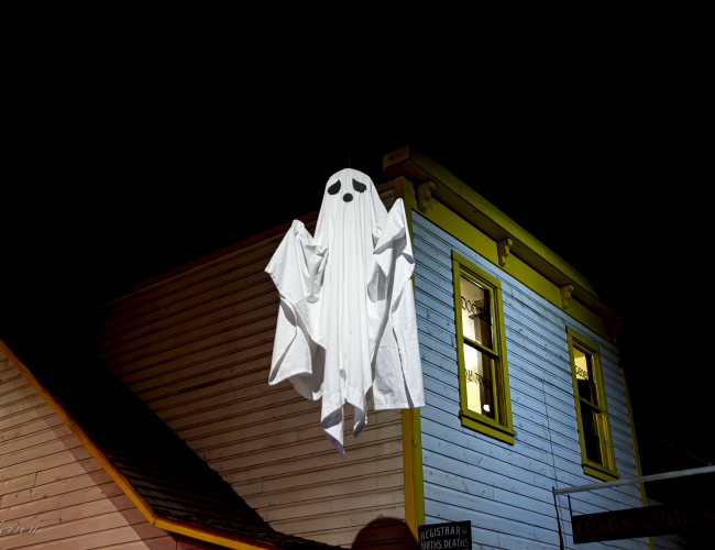 A ghost floating with a building in the background