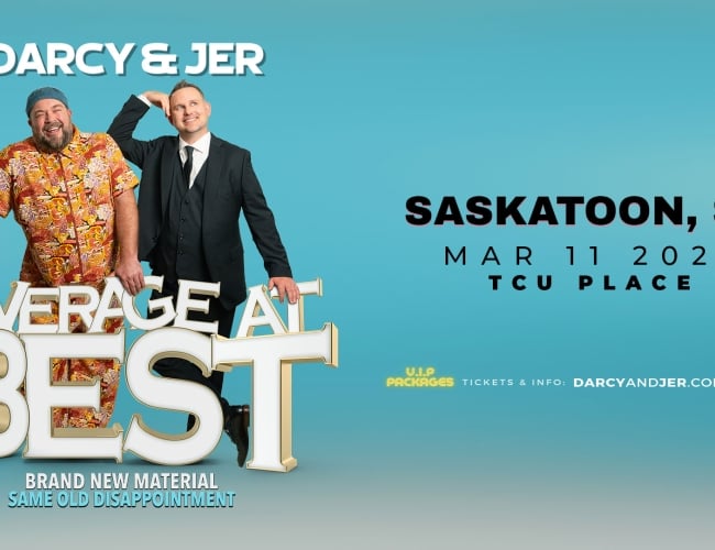 Two men on a blue background. One man is in a highly patterned suit and the other in a traditional black and white suit.