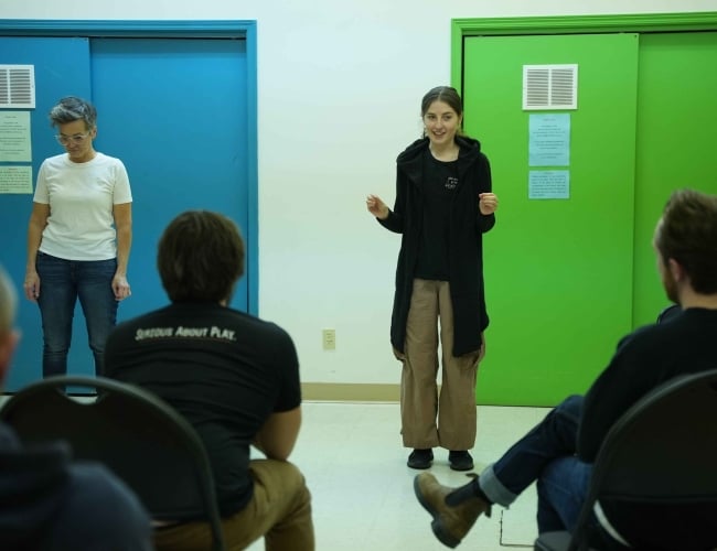 Picture of students in class, with facilitator explaining the exercise.