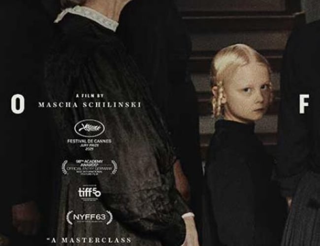 Image of three older women in all black clothing looking forward. A little blonde girl is looking towards the camera, dressed in black as well. Her eyes are intense but cannot read the emotion. 