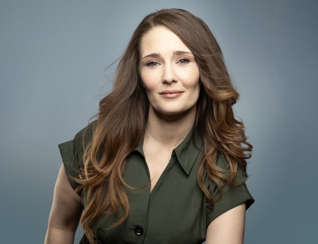 Meghan Haukaas headshot on blue background