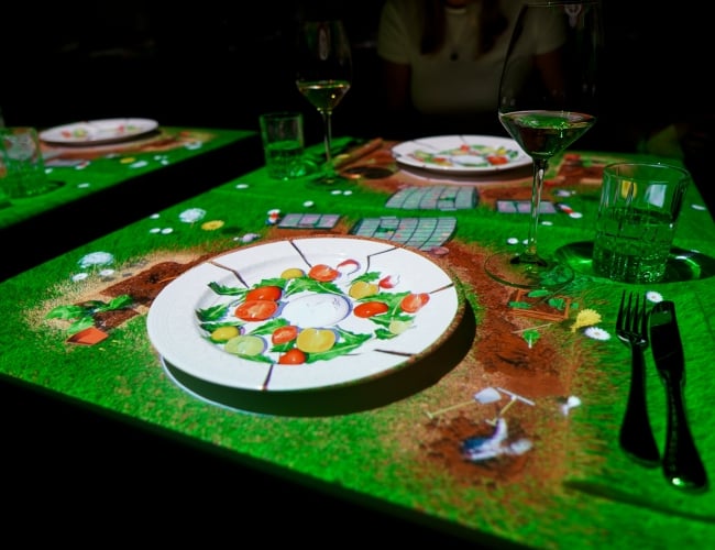 Dinner table with a cartoon scene projected on top