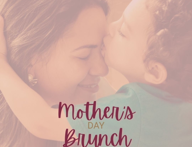 A male child kissing his mother on the forehead. With text overlapping that says Aroma Mother's Day Brunch Sunday, 10 May. 10am to 2pm