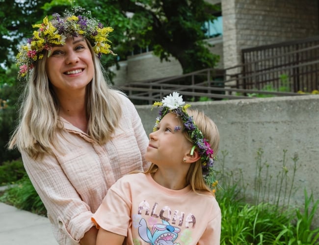 Photo of Kupala participants from summer 2025 wearing handmade vinky (floral wreaths) made out of wildflowers