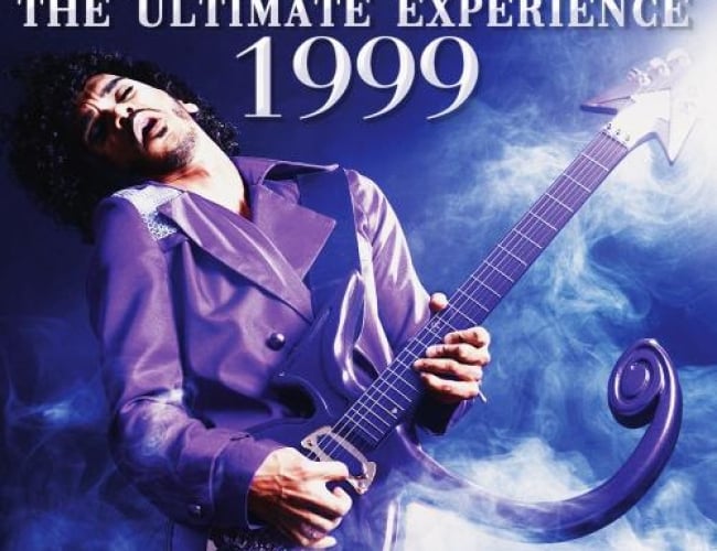 Image of tribute impersonator Prince playing the iconic guitar with smoke surronded all around them. 