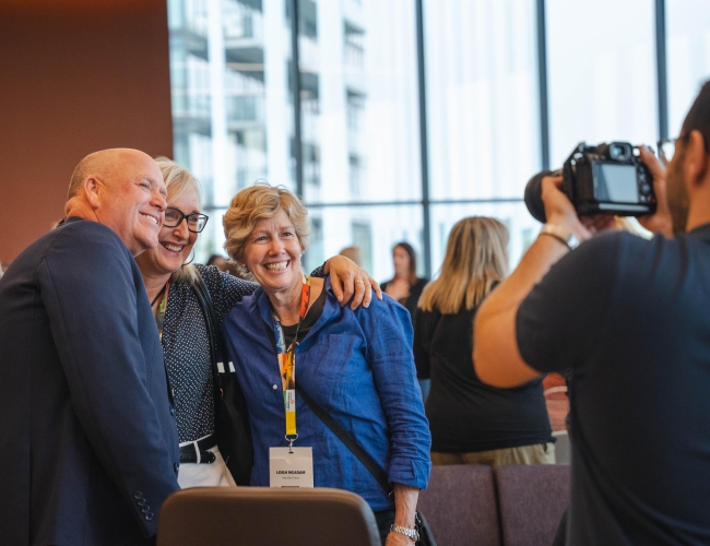 People at Conference Smiling Having Photo Taken