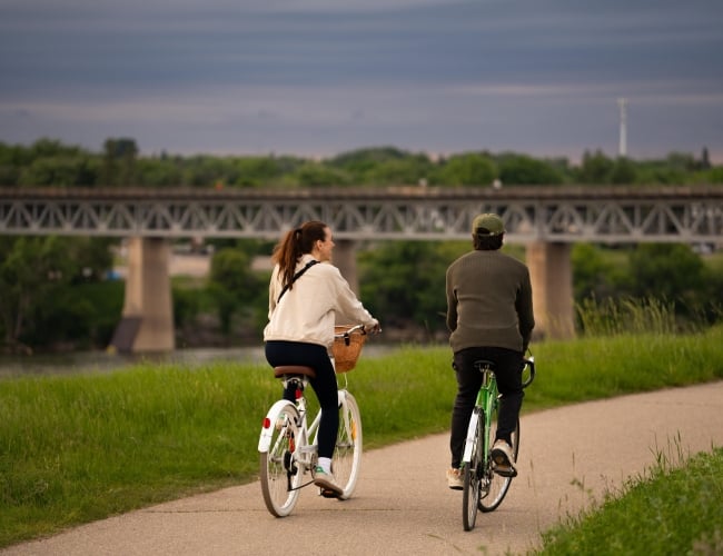 Couple Riding Bikes Down Meewasin Trail