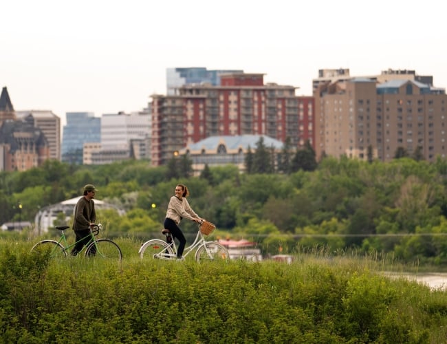 Couple on Bikes with Skyline in Background