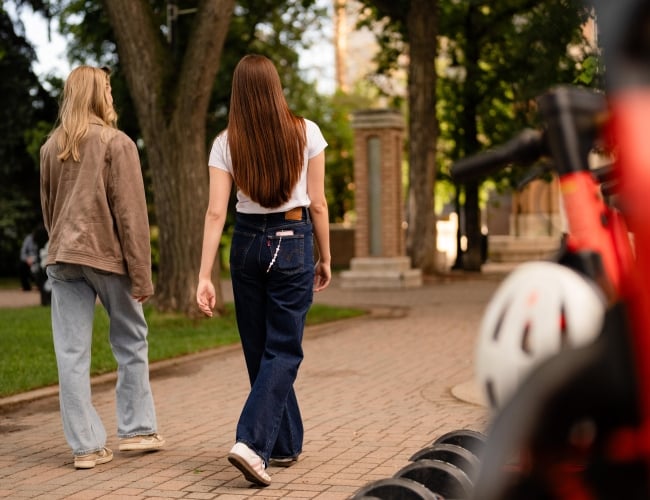 Girls Walking by Scooters