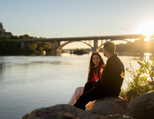 Couple Sitting on Rock at River Landing