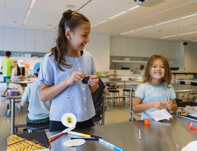 Two children enjoying an afternoon of art making in the Remai Modern learning studio.