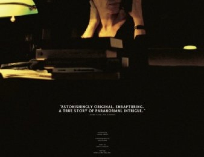 Image of a woman looking off to the side, holding a phone up to her ear and sitting in a dark library. 