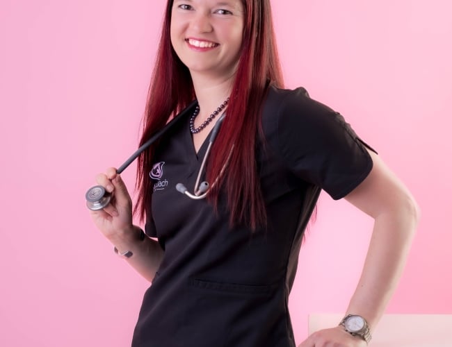 Nurse Nancy looking into the camera with her stethoscope. Pink background.