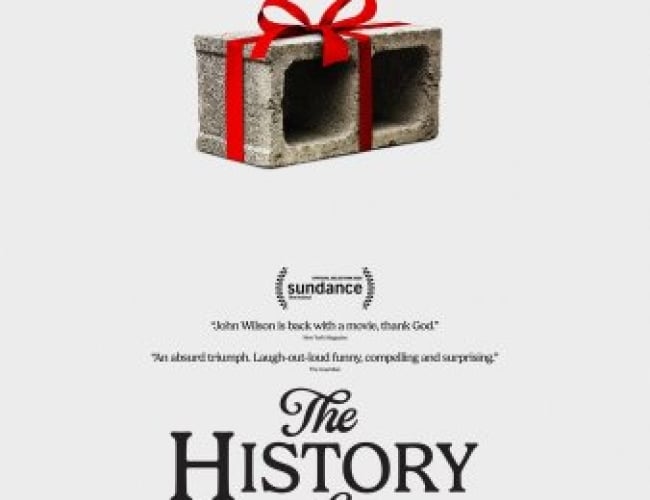 Image of a concrete block with a red ribbon tied around it, like a present.
