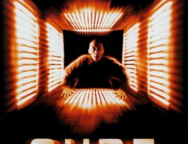 Image of a man in a jumpsuit entering a small square entryway, light up with very bright lights.
