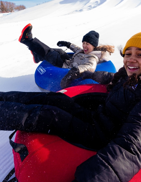 Children tubing in the snow