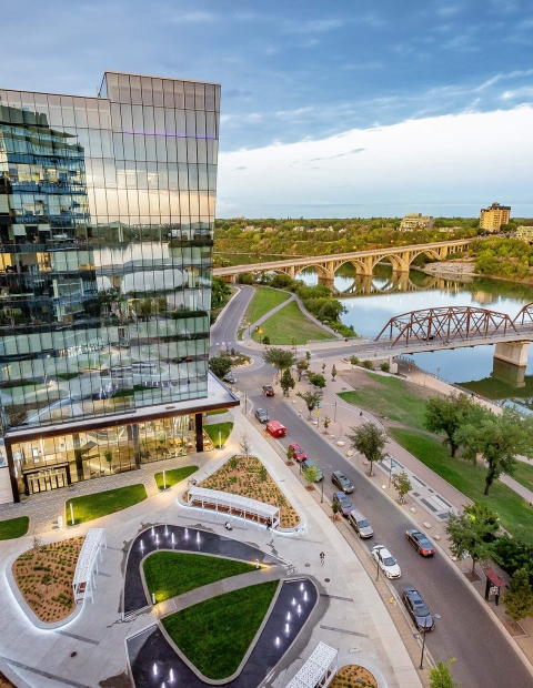 Aerial view of the city of Saskatoon with the river and large buildings in the background