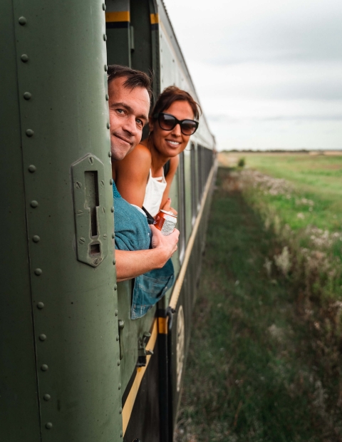 A couple looking out the window of a train
