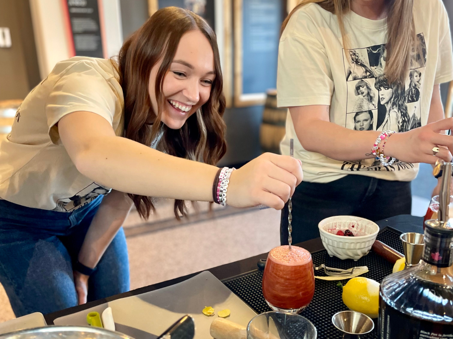 Female mixing cocktail that she created herself during Cocktail Class