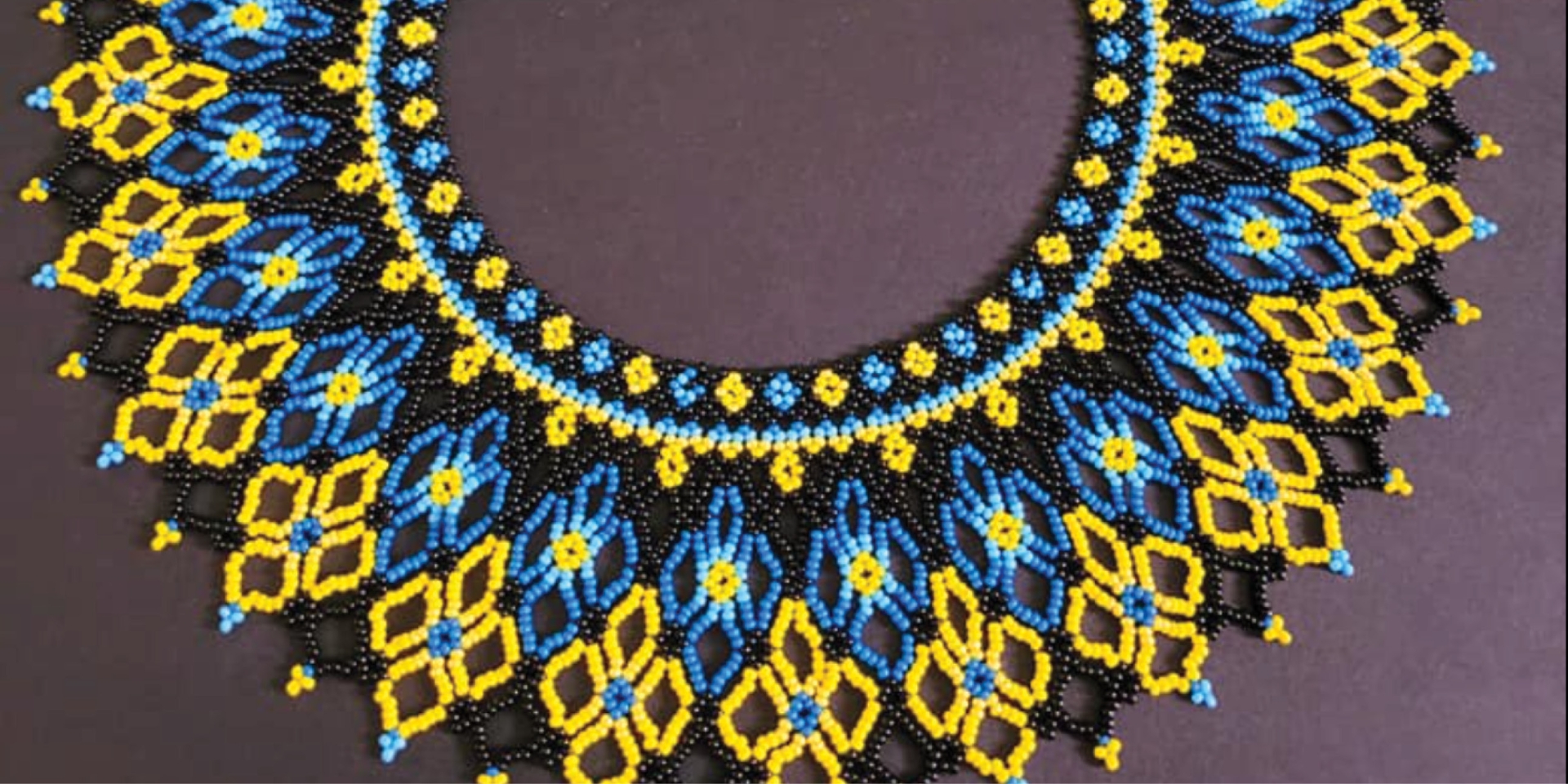 picture of a blue, yellow, and black Ukrainian beaded necklace (sylyanka)