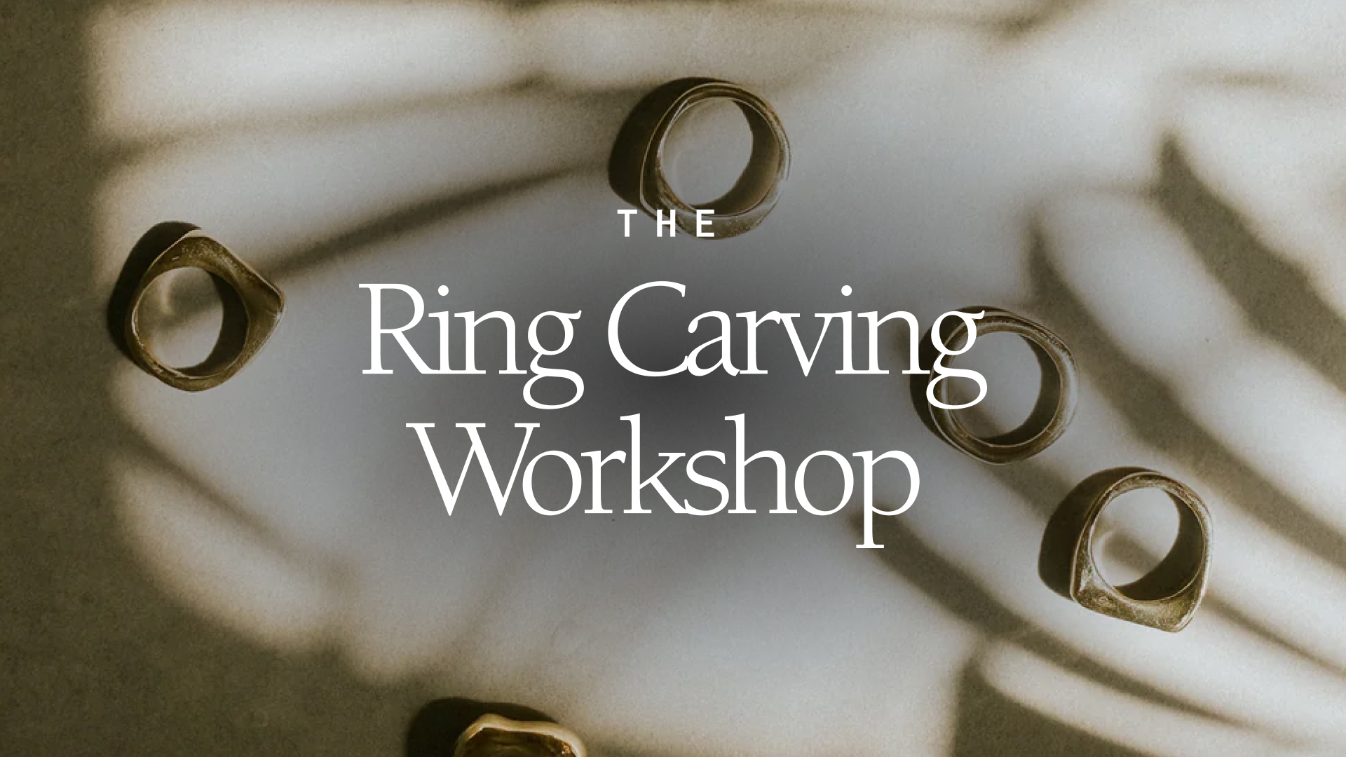 Image: The Ring Carving Workshop and behind the white text is an image of hand-carved rings made in the Canadian Prairies