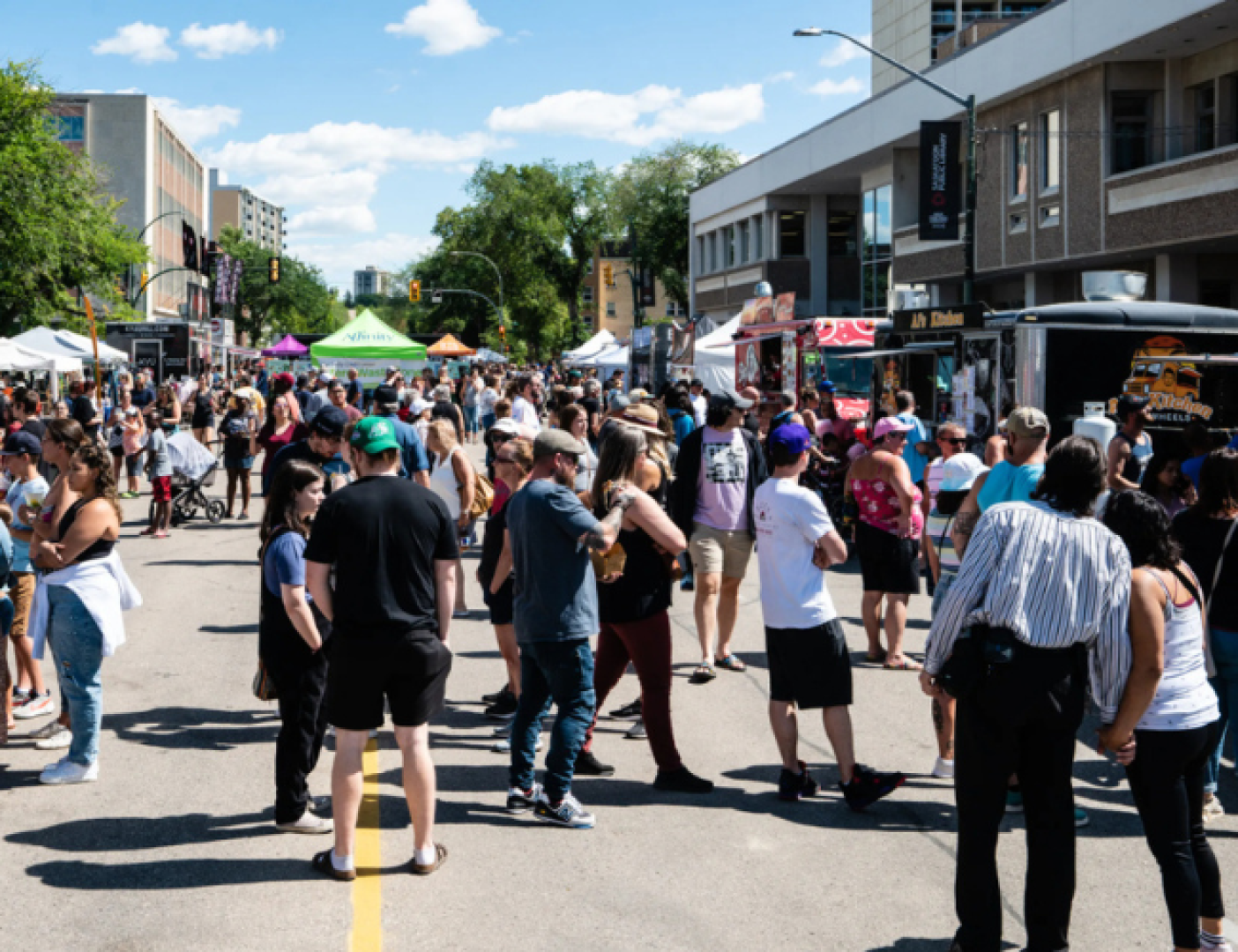 People waiting in line at a food truck in summer.
